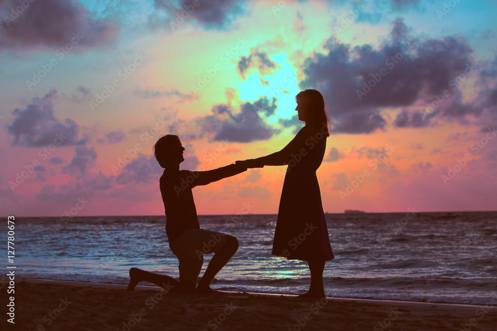 Marriage proposal at sunset beach