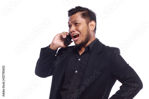 men showing his expression shouting while he pointing his talkin