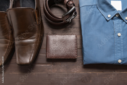 elegant set: brown men's shoes, brown leather belt, blue shirt,