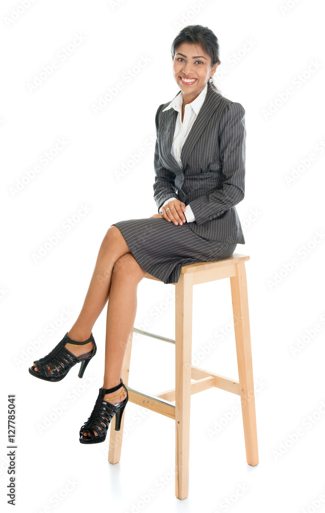 Black businesswoman seated on chair. Black businesswoman seated on chair.