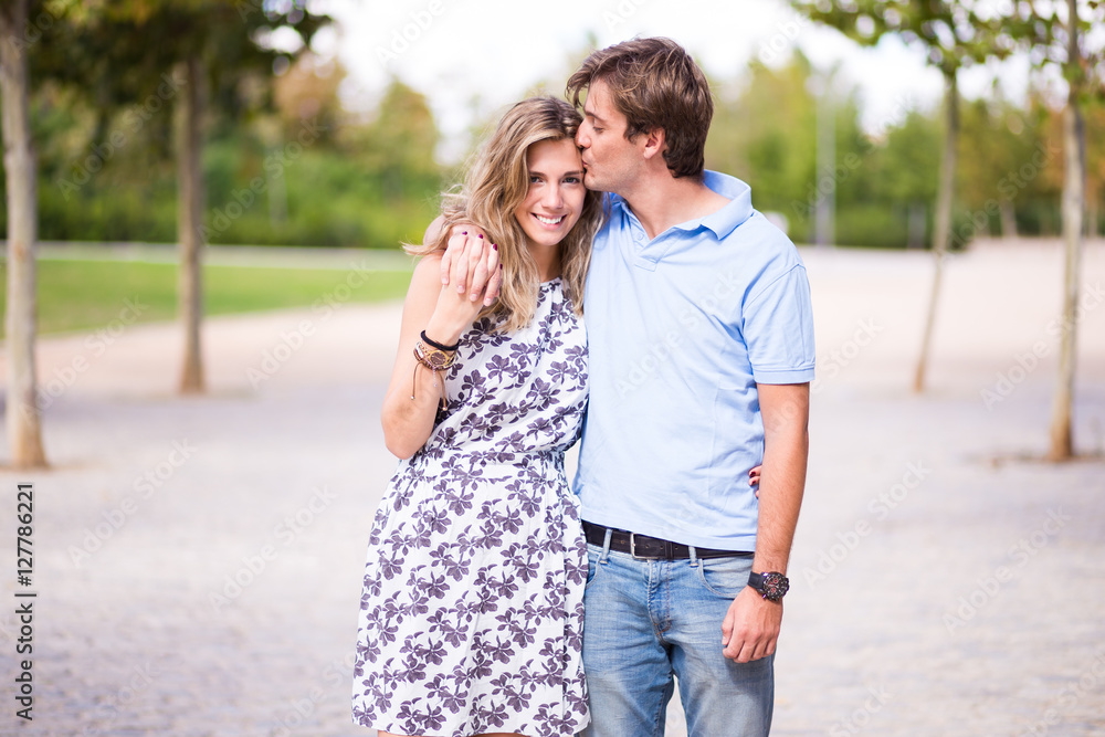 Portrait of smiling young and beautiful couple in the street Portrait of smiling young and beautiful couple in the street