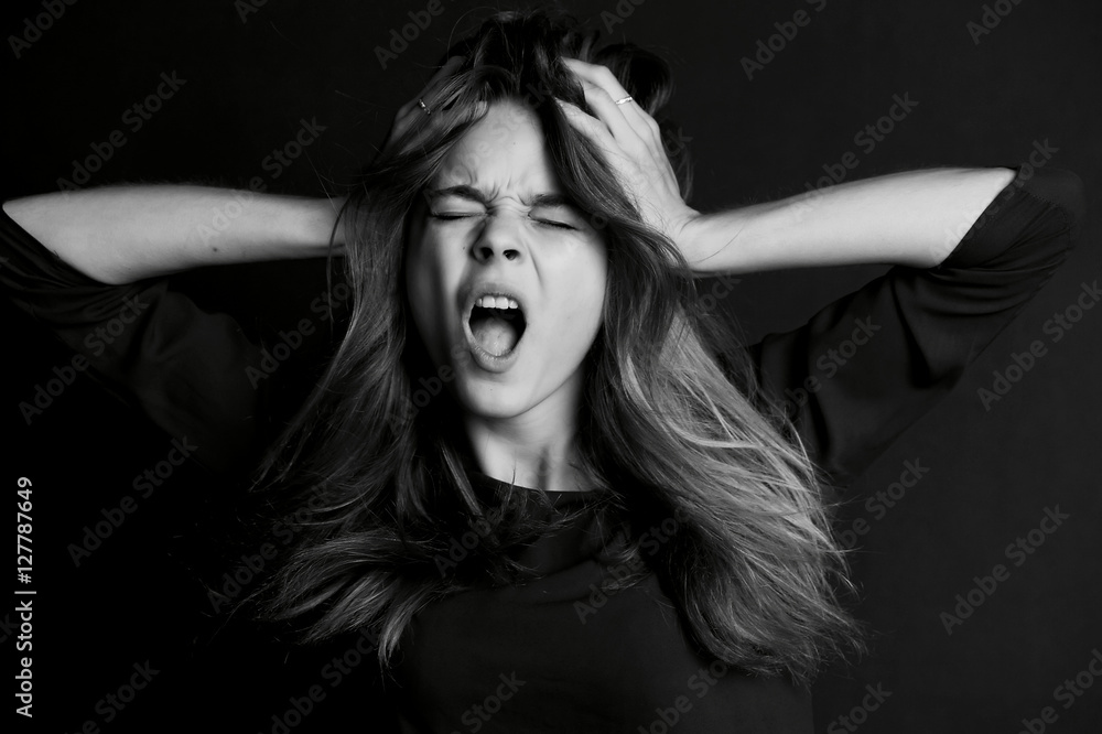 Beautiful girl with long hair yells. Black-white Beautiful girl with long hair yells. Black-white
