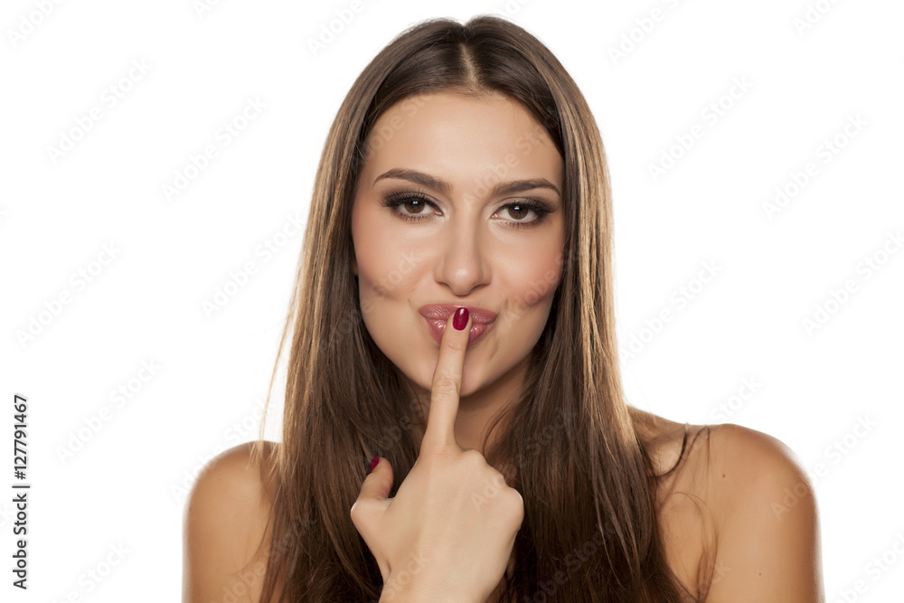 portrait from a beautiful happy woman kissing her finger portrait from a beautiful happy woman kissing her finger