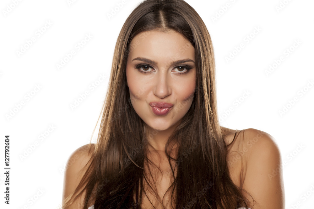 Fototapeta premium portrait from a beautiful happy woman with a kissing gesture