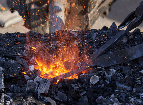 The heating of metal billets on hot coals