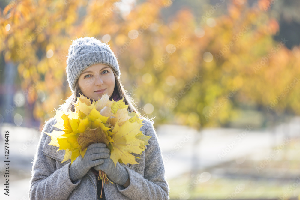 Young cheerful woman enjoying autumn outdoors Young cheerful woman enjoying autumn outdoors