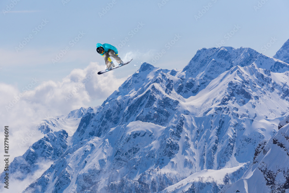 Flying snowboarder on mountains Flying snowboarder on mountains
