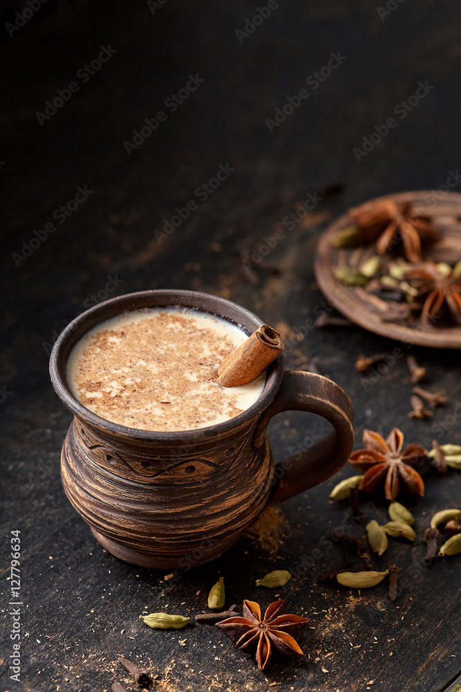 Milk tea chai latte traditional tasty refreshing morning breakfast sweet organic healthy hot beverage drink with natural aroma spices blend, cardamon, anise, cinnamon, in rustic ceramic cup
