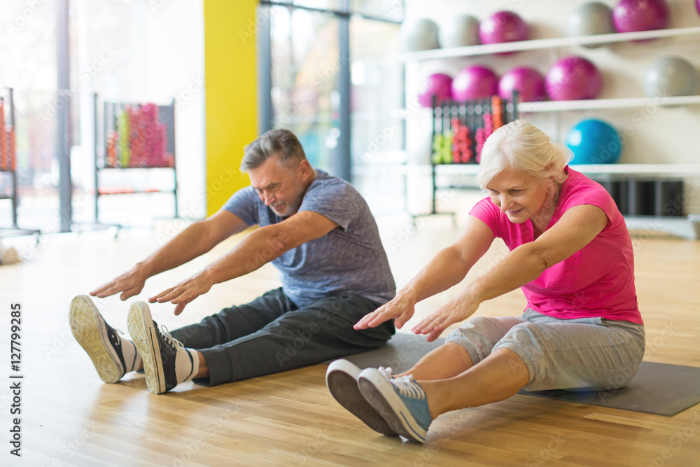 Senior couple exercising in gym
