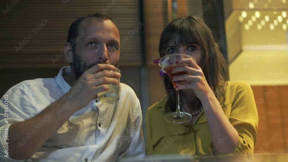 Happy, young couple talking and raising toast in cafe at night
Happy, young couple talking and raising toast in cafe at night