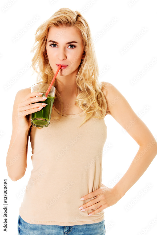 Young woman drinking green cocktail Young woman drinking green cocktail
