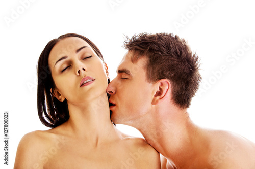 Handsome young man kissing woman's neck.