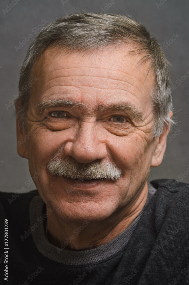 Portrait of an elderly man with a kind smile. Portrait of an elderly man with a kind smile.