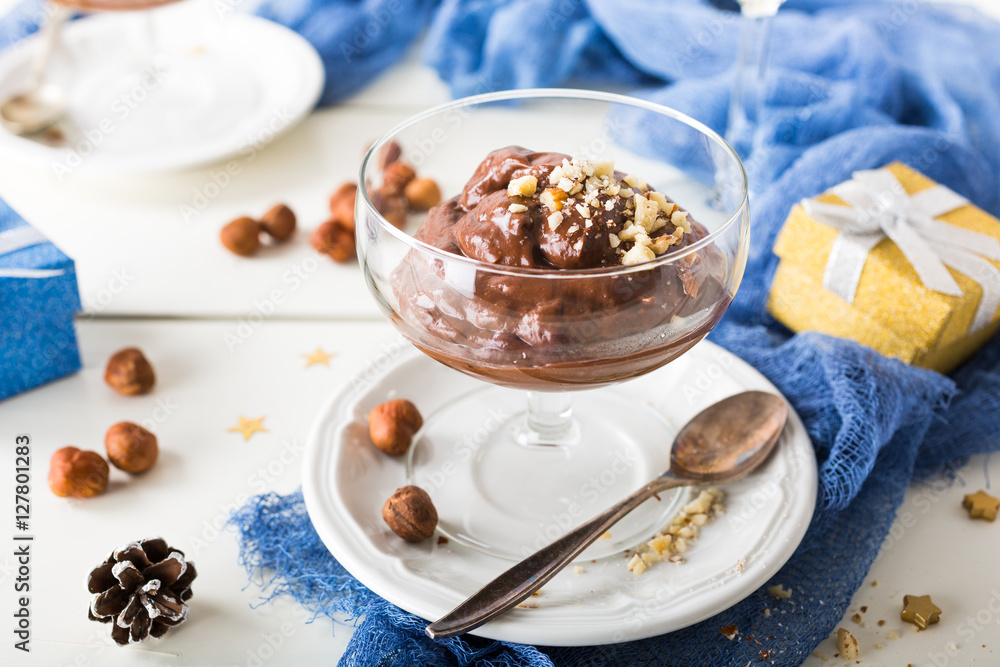 Chocolate pudding mousse with avocado, nuts and holiday decorations. Delicious Christmas themed dinner table. Chocolate pudding mousse with avocado, nuts and holiday decorations. Delicious Christmas themed dinner table.