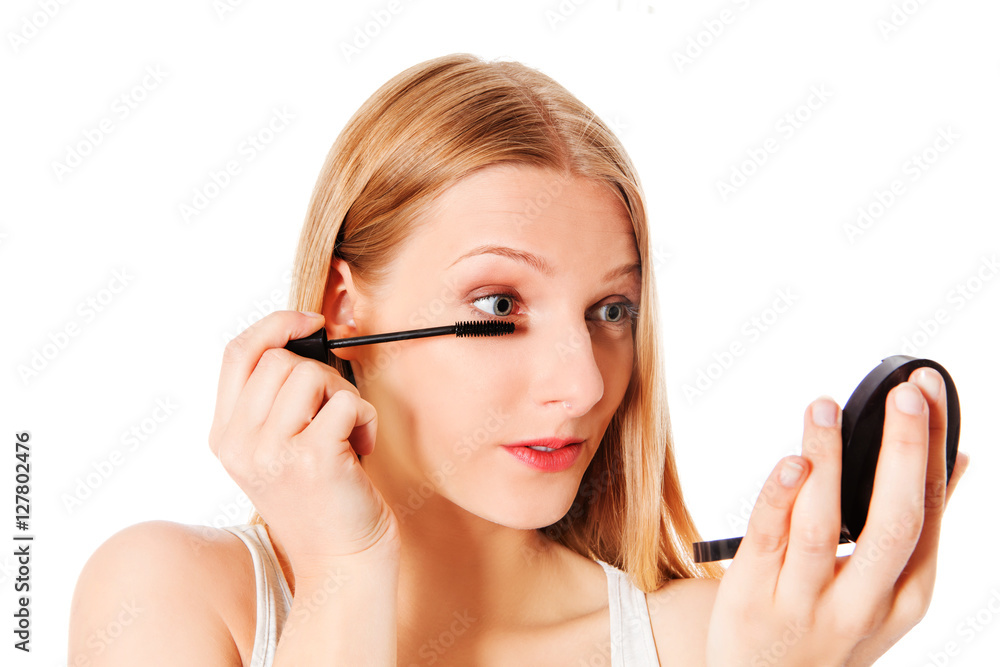 Attractive woman doing make-up on face. Isolated Attractive woman doing make-up on face. Isolated