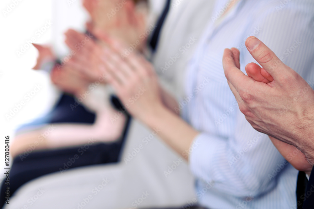 Close up of business people hands clapping at conference Close up of business people hands clapping at conference