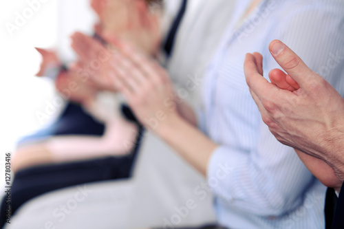 Close up of business people hands  clapping at conference