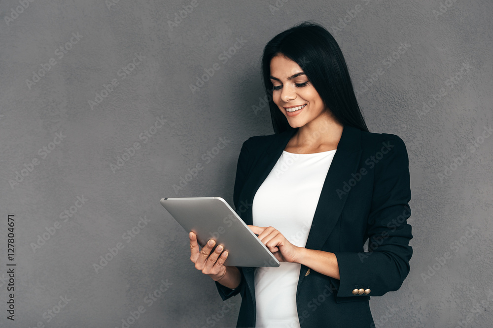 Examining her new tablet. Examining her new tablet.