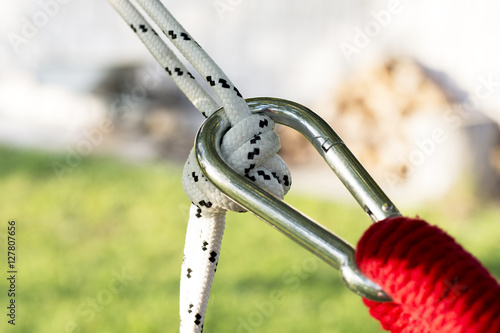 White rope connected by carabiner hook