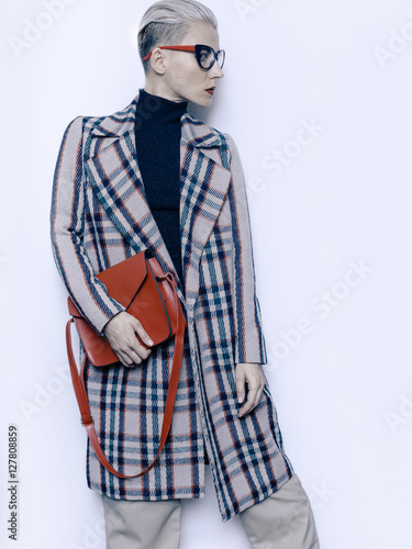 Stylish Blonde fashion vintage glasses and checkered coat Trend photo
