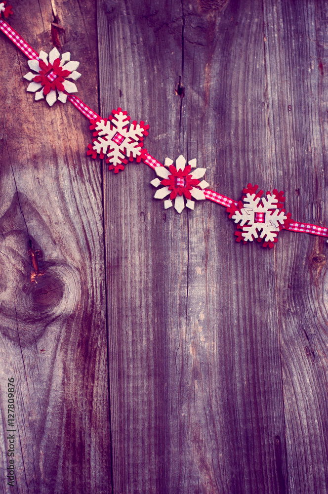 Felt snowflakes on a red ribbon to the left the empty space on w