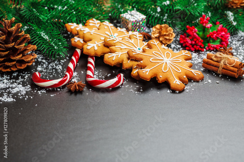 Fototapeta Naklejka Na Ścianę i Meble -  Christmas cookies with candy, cone and fir festive decoration with snow