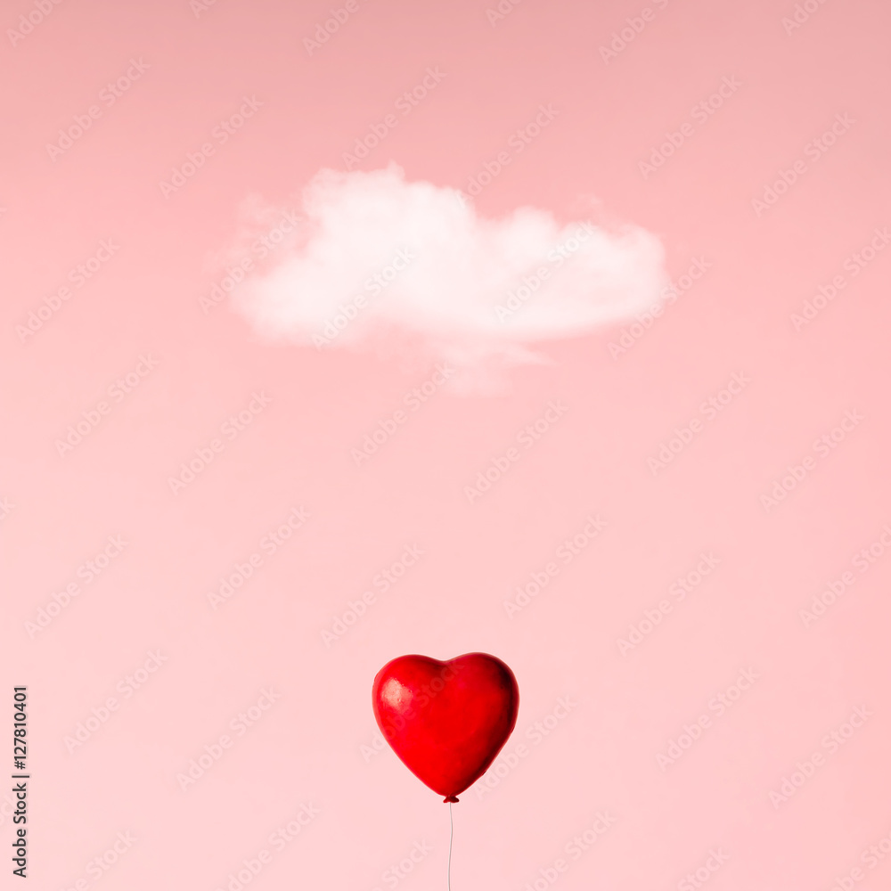 Ballon in heart shape on pink sky. Love concept.