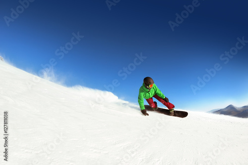 Man snowboarder rides slope sheregesh. Space for text