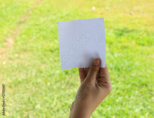 close up of a hand holding blank note paper