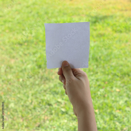 close up of a hand holding blank note paper