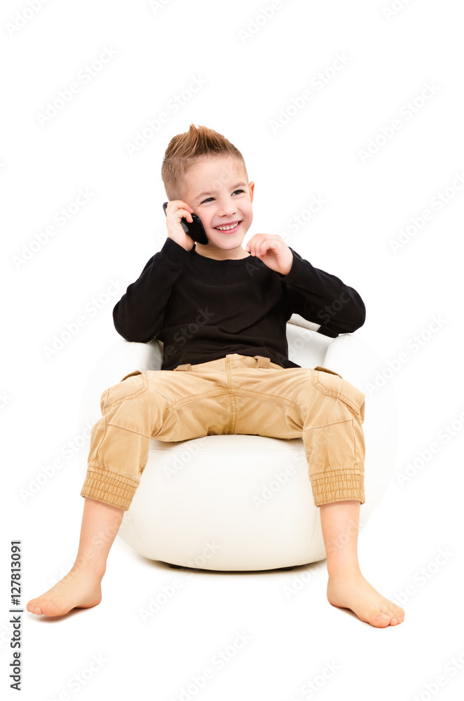Cheerful attractive kid talking on a mobile phone Cheerful attractive kid talking on a mobile phone