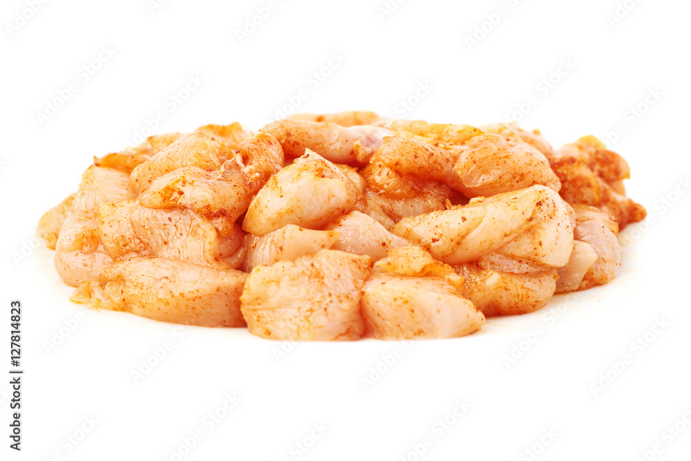 Raw chicken fillet cutted into pieces and spiced isolated over white background Raw chicken fillet cutted into pieces and spiced isolated over white background