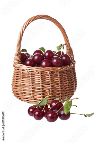 wattled basket filled with ripe cherries, isolated, a white background