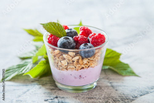 yogurt and muesli with berries on a table, selective focus,