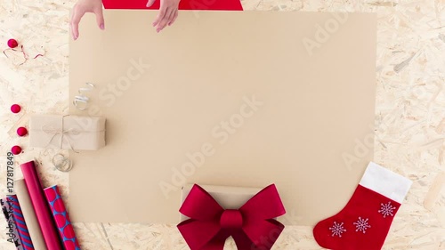 Video with woman wrapping small christmas gift
