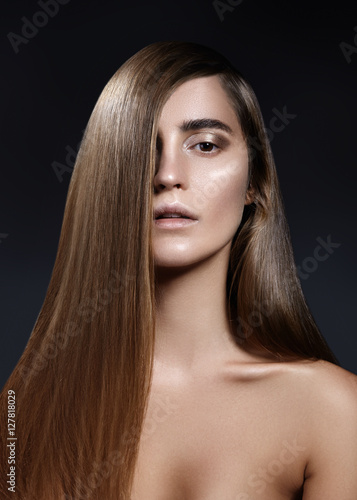Well being, wellness & spa. Sensual woman model with shiny straight long dark hair and fashion make-up. Health, beauty, hair-care, cosmetics and make-up. Beautiful fashion smooth shiny hairstyle