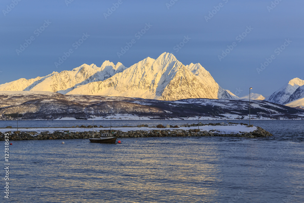 Ullsfjord in front of snow covered mountains of the Lyngen alps, Troms county, Norway