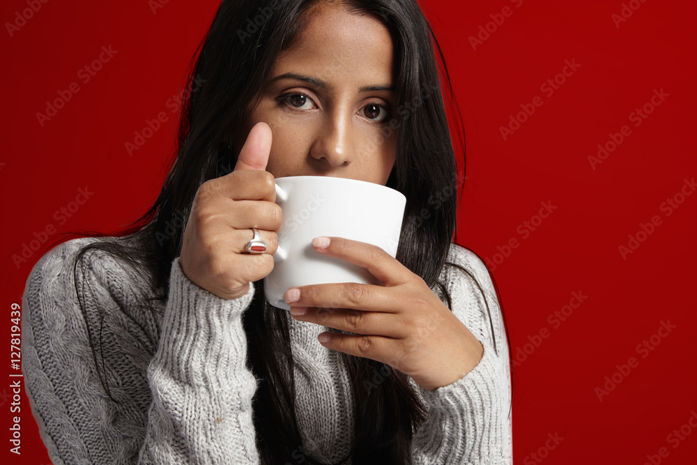 woman with brunette straight hair drinks hot coffe at cold time