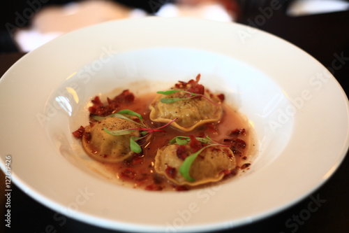 Cabbage ravioli with bacon in pepper sauce