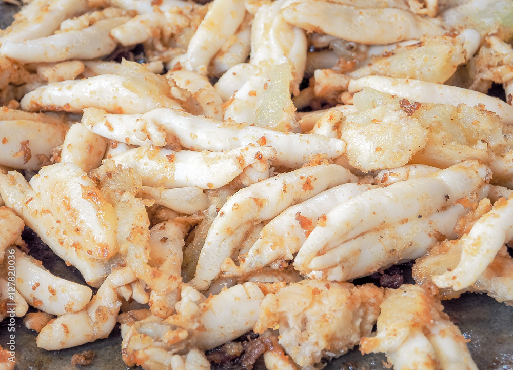 Egg fried squid in street food market, Thailand / Selective focus and Close up for food image Egg fried squid in street food market, Thailand / Selective focus and Close up for food image