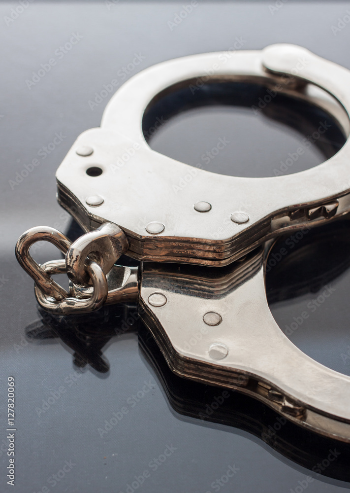 Obraz premium Handcuffs isolated on black