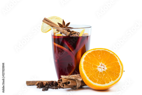 Cup of hot wine with spices on white background photo