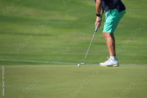 Playing golf preparing to shot,man putting on green