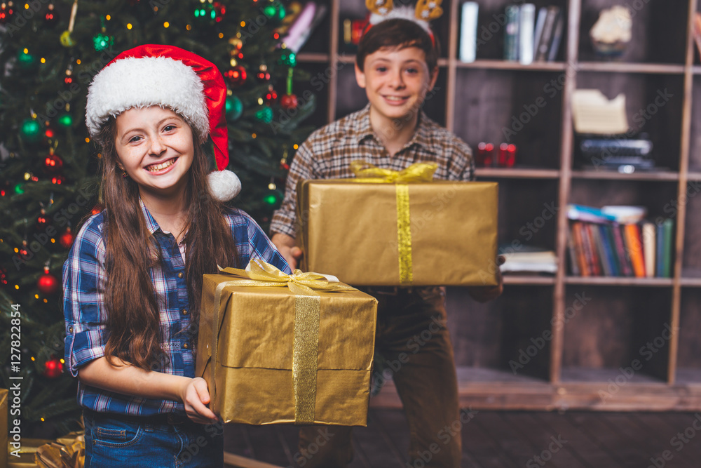 Christmas concept. New Year. Happy children with Christmas gifts. Children smile. Children hold the big boxes in hands