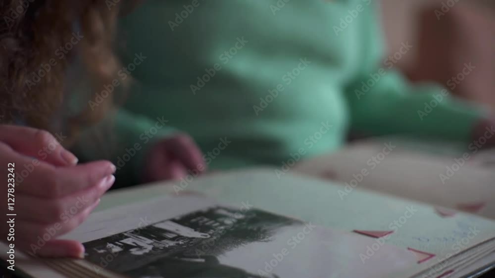 happy family with book or photo album sitting on couch at home happy family with book or photo album sitting on couch at home