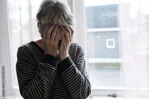 worried senior woman at home felling very bad