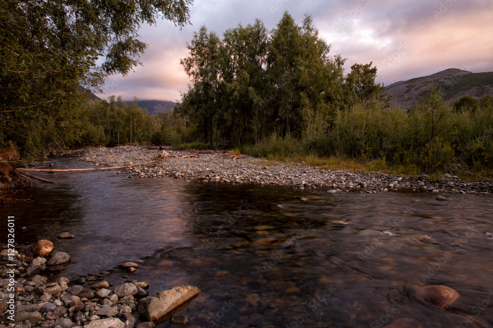 River in the forest and sunset. Magadan region, Koni peninsula, Hindzha river, Russia. River in the forest and sunset. Magadan region, Koni peninsula, Hindzha river, Russia.