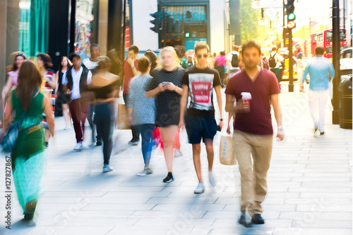 Blurred image of walking people. Londoners and tourists walking in Oxford street, one of the main shopping destination of London