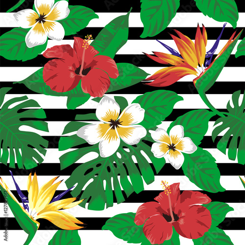Tropical flowers and leaves on striped background. Seamless. 