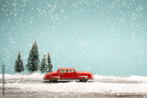 Vintage toy car in a winter landscape
